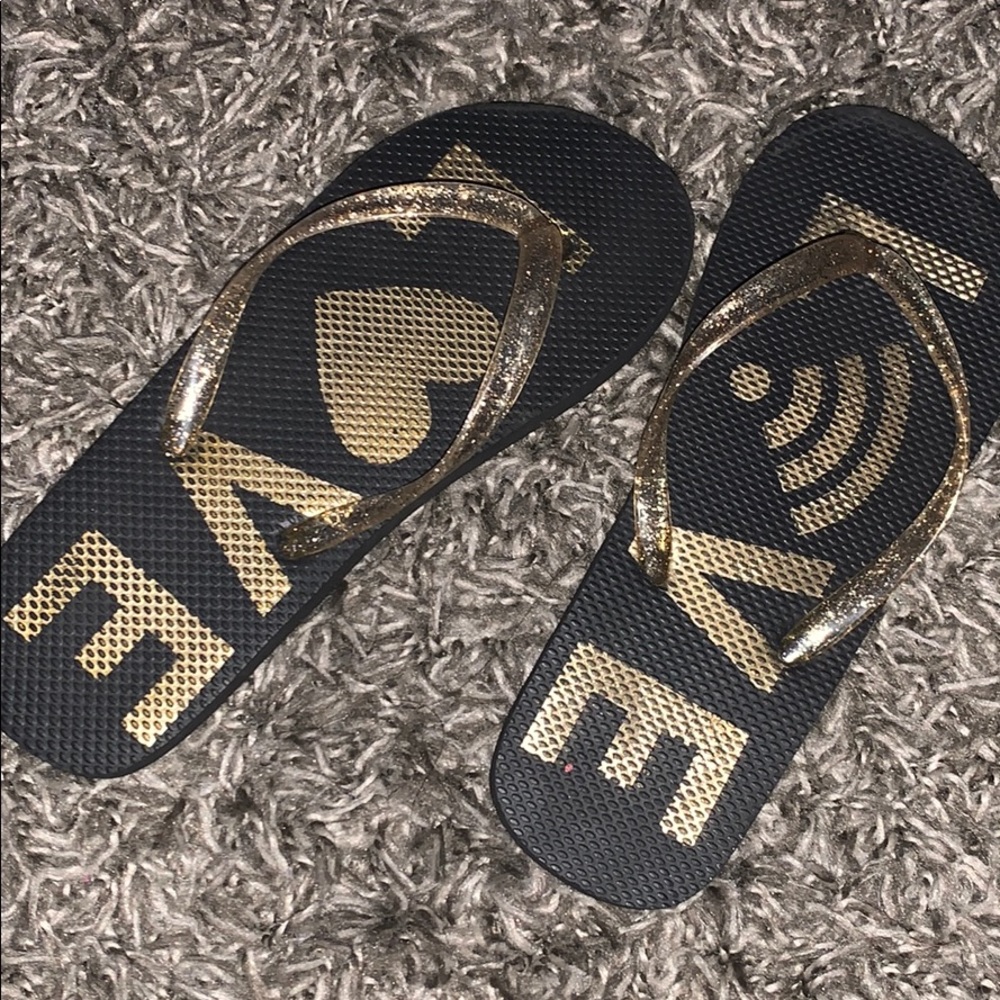 black and gold ‘love’ flip flops